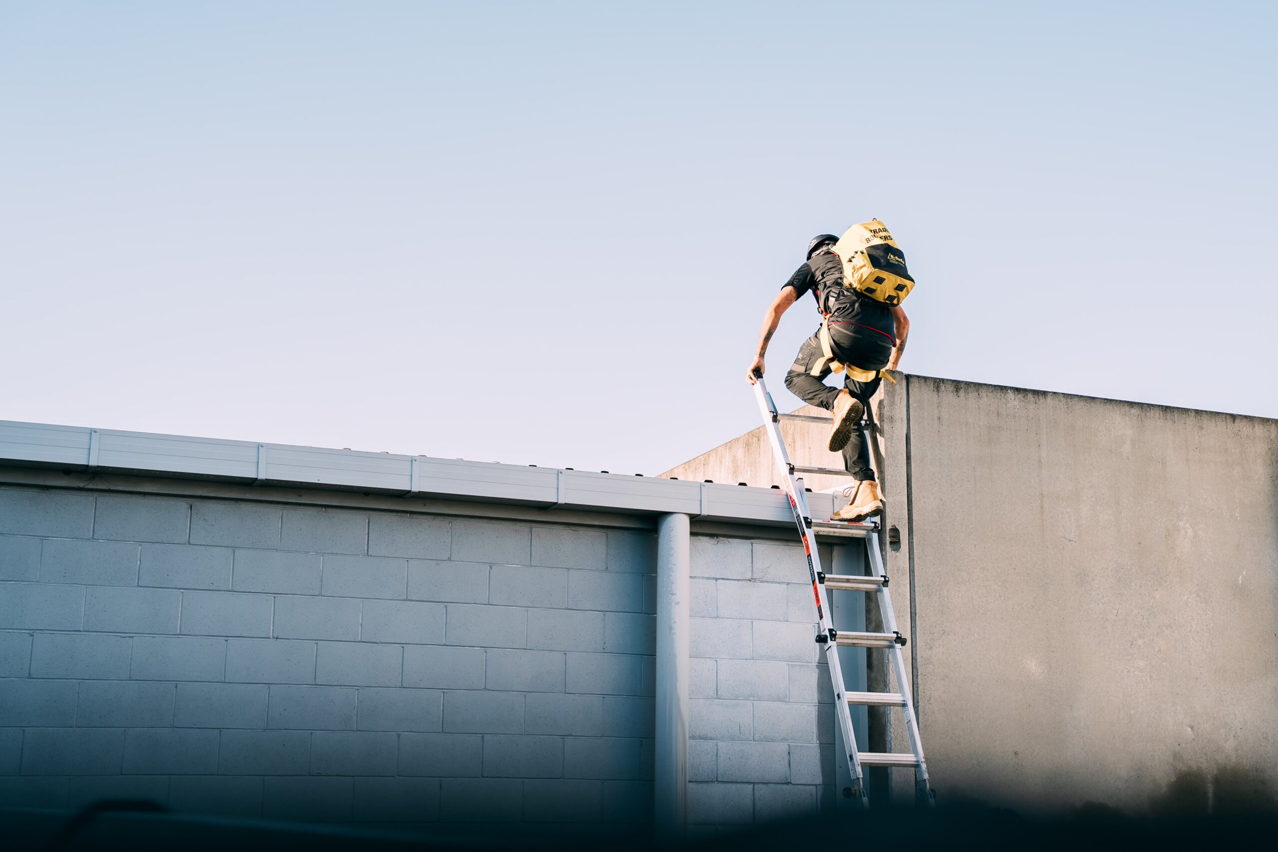 Worker climbing on roof